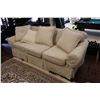 Image 1 : Three seat cream coloured upholstered sofa with throw cushions