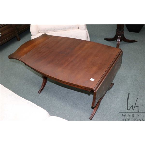 Mid 20th century coffee table with matched grain top and drop leaves, lyre supports and brass capped