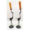 Image 1 : A PAIR OF BLACK-PAINTED METAL CRANE FIGURAL CANDLESTICKS