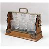 Image 1 : AN OAK FRAMED TANTALUS WITH WHITE METAL HANDLE