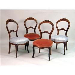 A SET OF FOUR VICTORIAN CARVED ROSEWOOD DINING CHAIRS