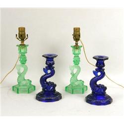 A PAIR OF GREEN SANDWICH GLASS DOLPHIN-FORM CANDLESTICKS
