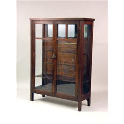 AN ARTS AND CRAFTS FIGURED OAK GLAZED BOOKCASE