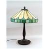 Image 1 : A TIFFANY-STYLE LEADED GLASS AND PATINATED METAL TABLE LAMP
