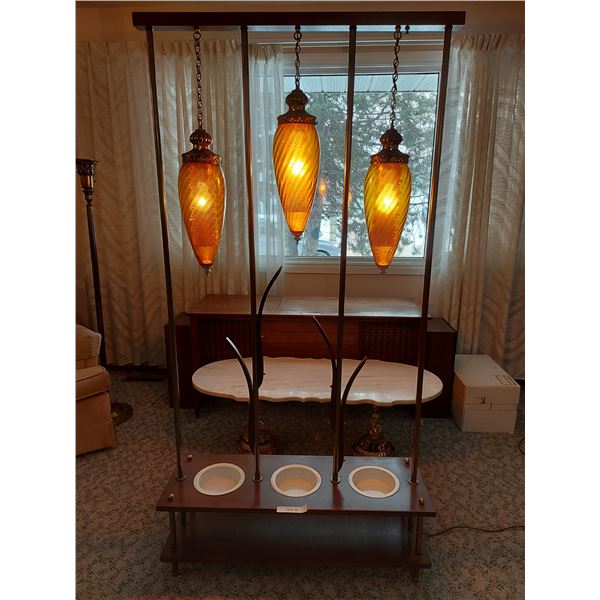 Vintage plant holder/room divider with large lights.