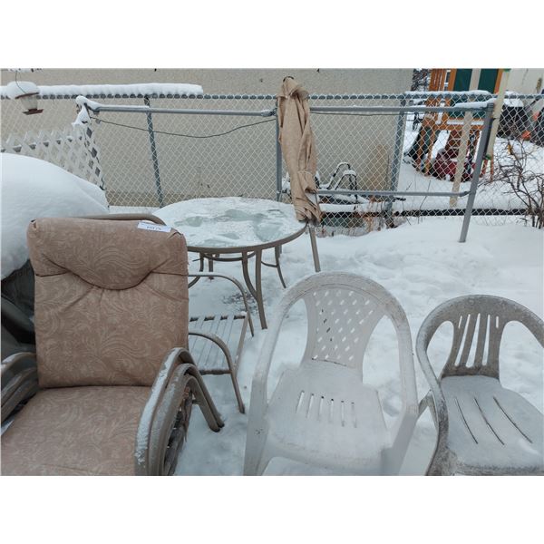 Round glass top patio table with umbrella and 6 asst chairs; asst chair cushions