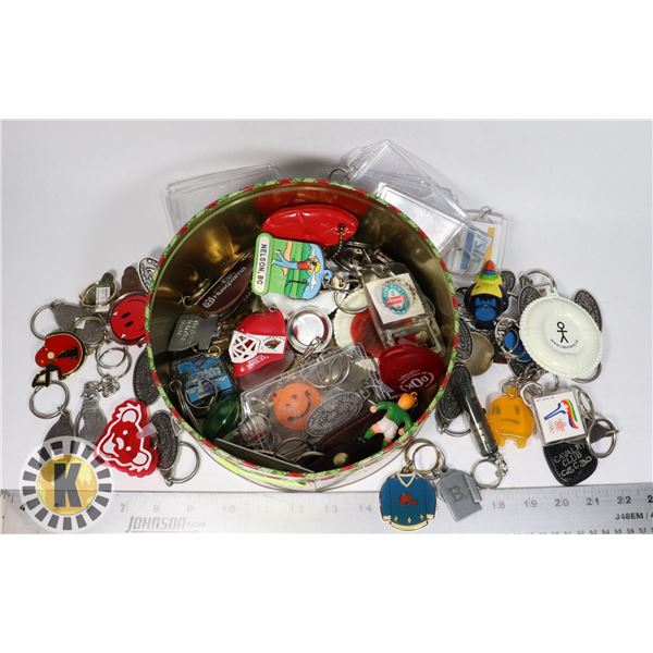 TIN CASE FULL OF ASSORTED KEYCHAINS