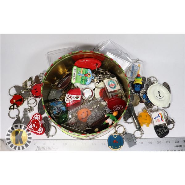 TIN CASE FULL OF ASSORTED KEYCHAINS