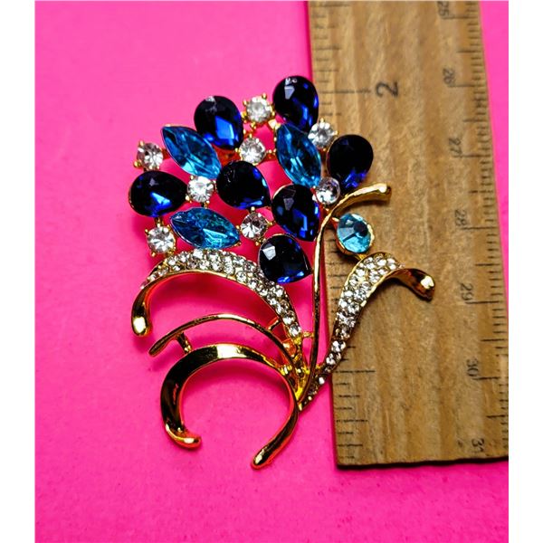 7)  GOLD TONE WITH SAPPHIRE BLUE AND CLEAR AND