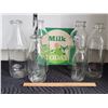 Image 1 : Vintage milk bottles from different time periods & window sign.