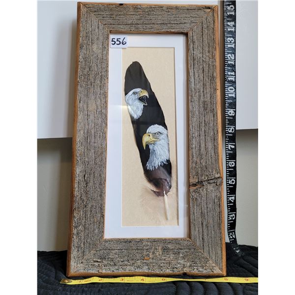 Matted and framed in barn board, a painted feather of eagles by the metis artist Lucille Scott.
