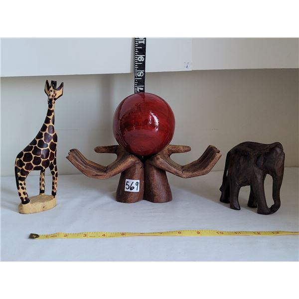Wooden elephant & giraffe carvings. Wood offering hands & ball.
