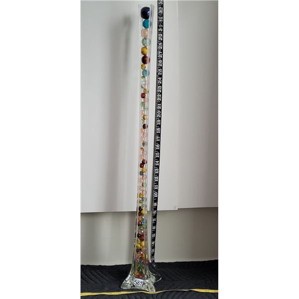 Tall 31”unique rose vase filled with assortment of marbles.