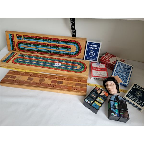 3 cribbage boards, one made in New Zealand from native timber. 6 decks of cards, 3 rubik type puzzle