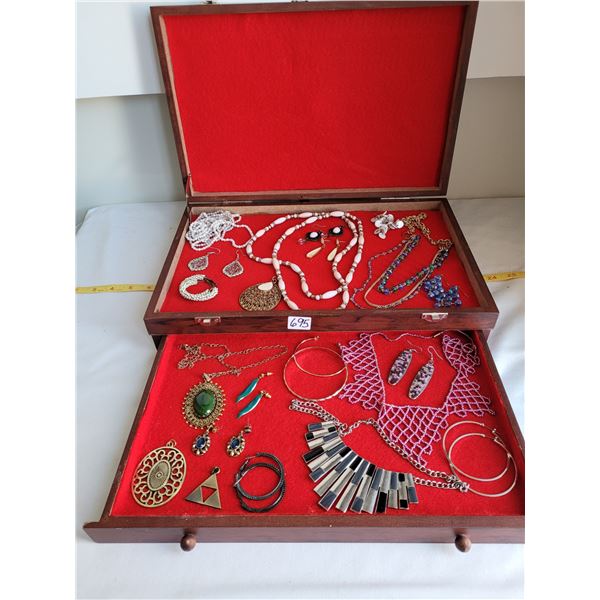 Assortment of costume jewelry in box with drawer.