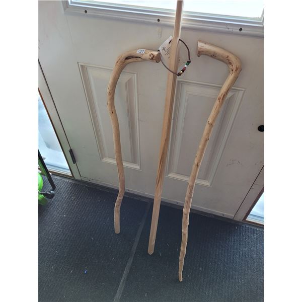 3 wooden walking sticks.