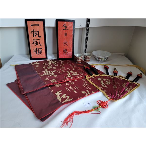 Lot of oriental items. 6 place mats & chopsticks, 2 writings, cups & bowl.