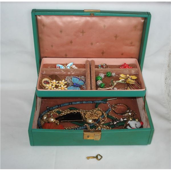 Vintage jewelry box with jewelry and key
