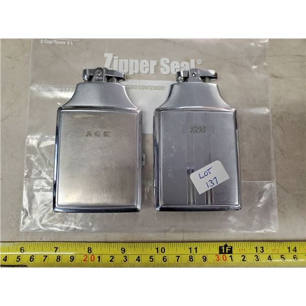 TWO CIGARETTE CASES W/ LIGHTERS ON TOP