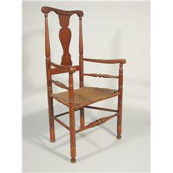 A 19th Century American walnut armchair with caned seat.