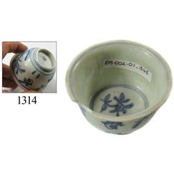 Chinese blue-on-white porcelain teacup, trees/birds design.