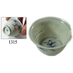 Chinese blue-on-white porcelain teacup, trees/birds design.