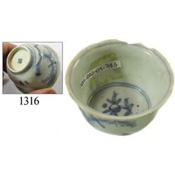 Chinese blue-on-white porcelain teacup, trees/birds design.