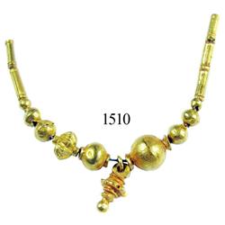 Lot of 13 small gold beads and one gold pendant strung together on a wire.