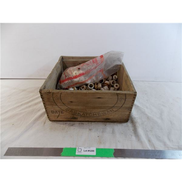 Saskatchewan wooden crate filled with small ceramic insulators