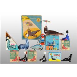 Lot of 7: Tin Seal Toys.