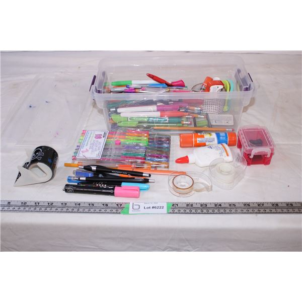 Plastic container with various pens,pencils,glue,tape