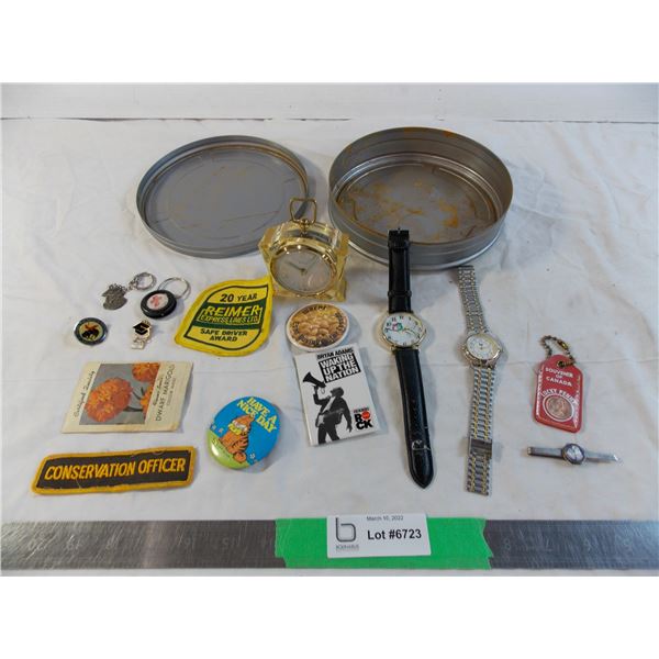 Watches, movie reel tin filled with trinkets, badges, misc