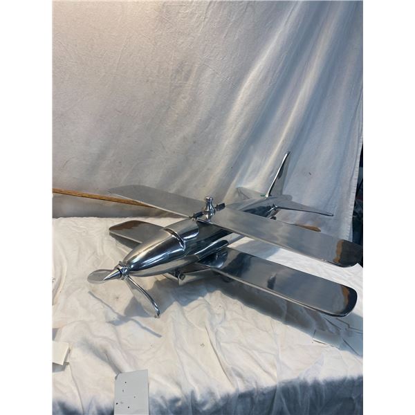 Large chrome metal airplane. 25 inches long. Damaged propeller