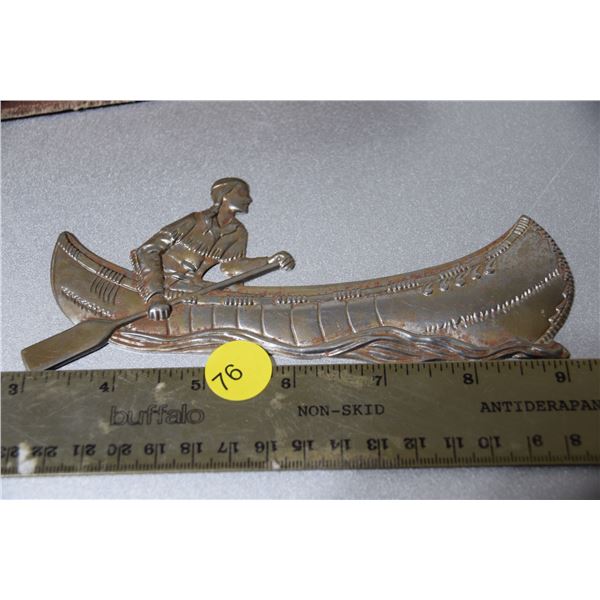 Metal 'native in canoe' plaque