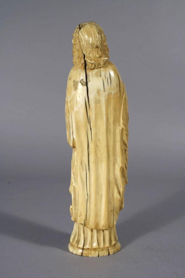 A Continental 19th Century Carved Ivory Religious Figure Holding