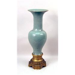 A LARGE CHINESE CELADON VASE ON A GILT-METAL BASE