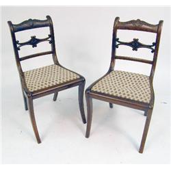 A PAIR OF REGENCY CARVED MAHOGANY SABRE LEG SIDE CHAIRS