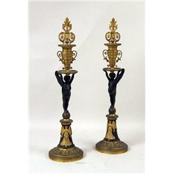 A PAIR OF CHERUB FIGURAL BRONZE AND BRONZE DORE CANDLESTICKS