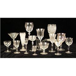 AN ASSORTMENT OF COLORLESS STEMWARE IN VARIOUS PATTERNS