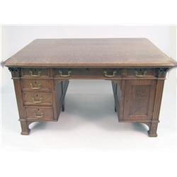 A VICTORIAN CARVED AND FIGURED OAK PARTNER`S DESK