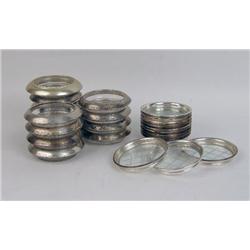 A SET OF FRANK M. WHITING STERLING SILVER-MOUNTED GLASS COASTERS