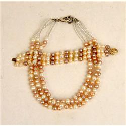 A THREE STRAND WHITE, PINK AND MAUVE PEARL NECKLACE