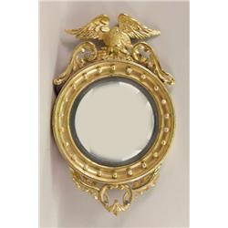 A FINE FEDERAL GILTWOOD CONVEX BULLSEYE MIRROR WITH EAGLE FINIAL