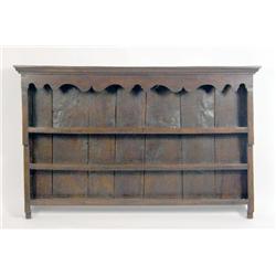 A STAINED OAK HANGING PLATE RACK