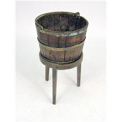 A GEORGIAN BRASS BANDED OAK PEAT BUCKET ON STAND