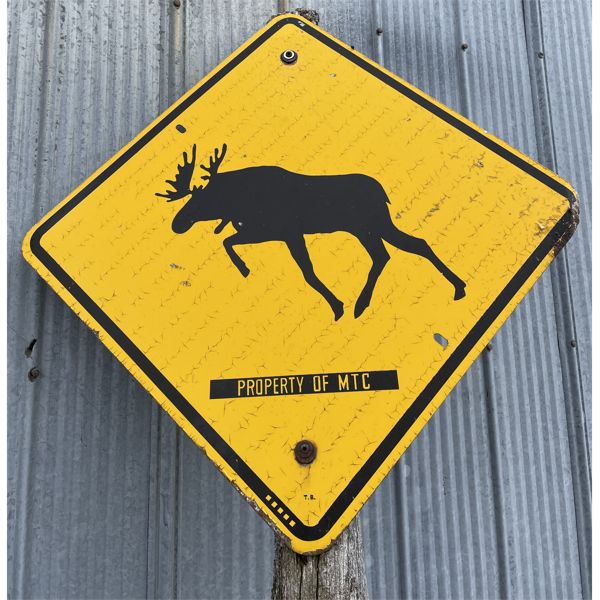 MOOSE CROSSING STREET SIGN ON POST 