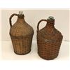 Image 1 : Two antique glass bottles in woven wicker handled coverings from movie set
