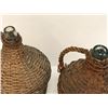 Image 3 : Two antique glass bottles in woven wicker handled coverings from movie set