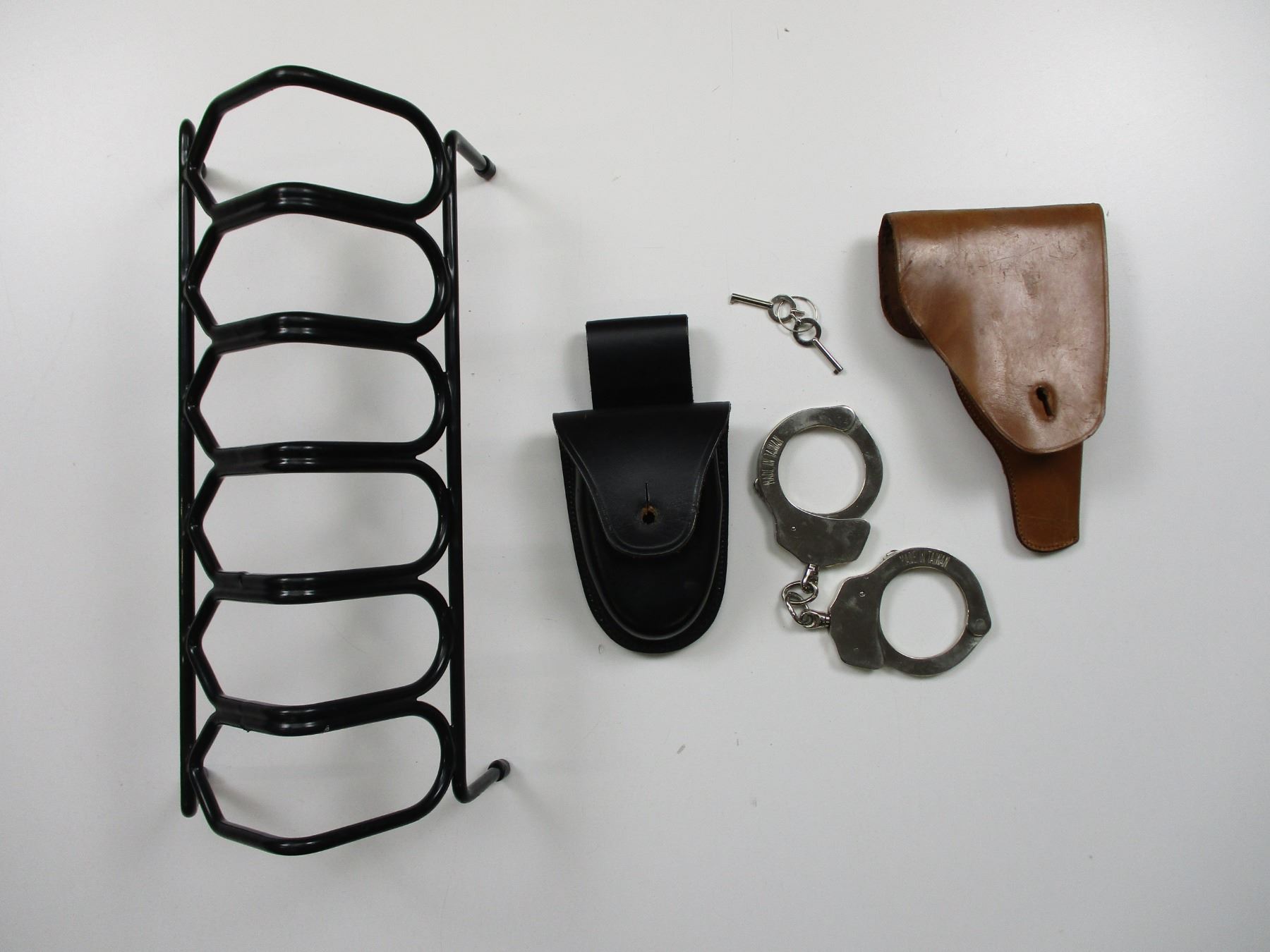 PISTOL RACK WITH HANDCUFFS ETC