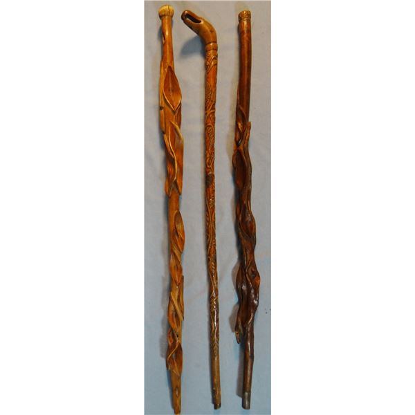Three diamond willow carved walking sticks